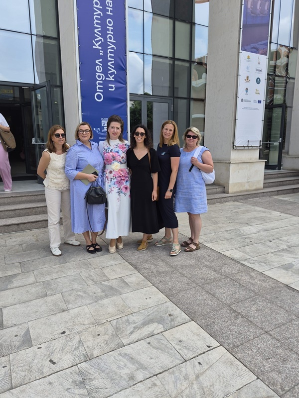 A group of women standing in front of a building