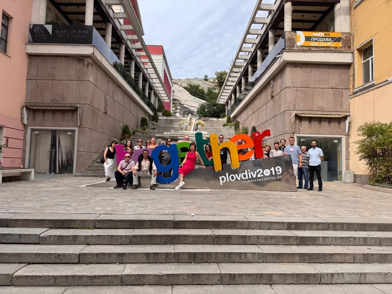 A group of people posing for a photo in front of a sign