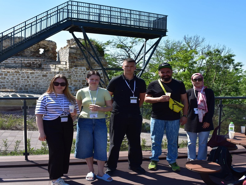 A group of people posing for a photo in front of a building AI-generated content may be incorrect.