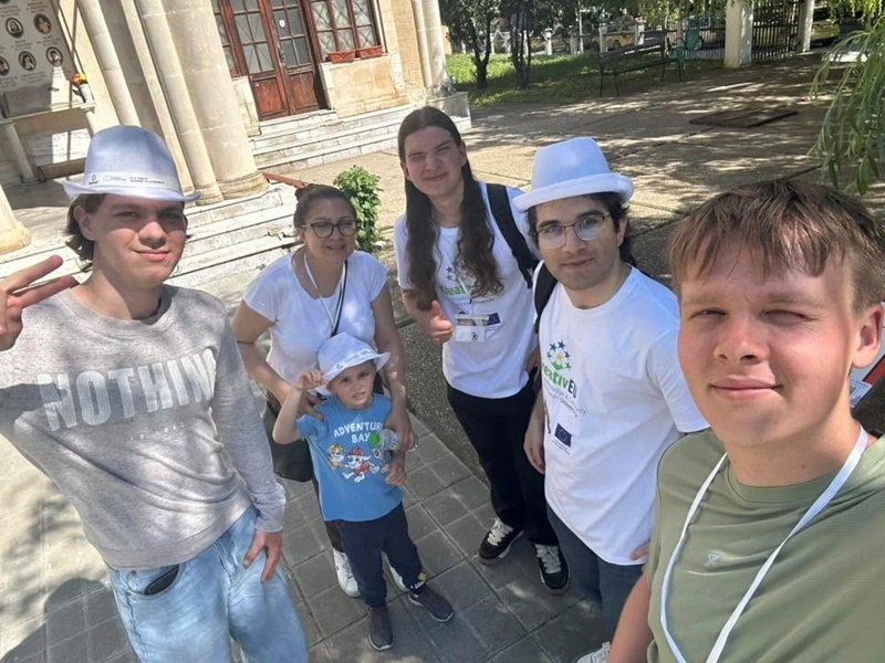 A group of people posing for a photo in front of a building AI-generated content may be incorrect.